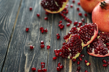 Ripe pomegranate fruit on wooden background