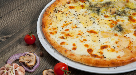 pizza quatrro fromaggi (four cheese) on a wooden table