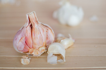 Half of garlic with one piece on wooden background, Halved garlic, Half of garlic Garlic close up, garlic detail - shallow of depth