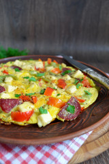 Frittata with peppers, salami and cheese, Italian breakfast
