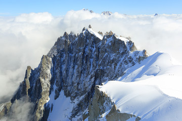 Mont Blanc mountain peak above low clouds