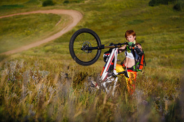 Extreme sports - young woman with downhill bike