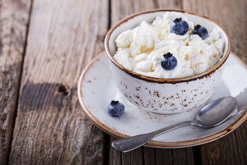 Homemade cottage cheese in a plate, with blueberries.Breakfast.Healthy food.selective focus.