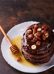 Chocolate pancake with honey and hazelnuts.selective focus