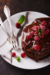 Chocolate pancake with chocolate glaze,raspberries and mint.selective focus