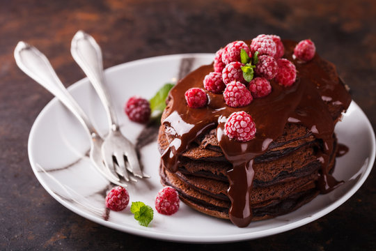 Chocolate pancake with chocolate glaze,raspberries and mint.selective focus
