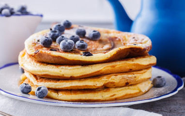 Pancake with banana , blueberries and honey.