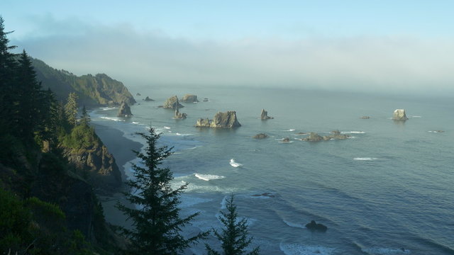 Early morning locked down (first 7 secs) and slow panning view of China Beach as seen from above, in Samuel H. Boardman State Scenic Corridor, southern Oregon coast; Panasonic GH4.