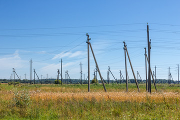 Electric poles electrical substation in the field in a sunny summer day