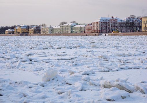 St. Petersburg in the winter. View through the frozen river Neva on the architecture of the University Embankment, Saint-Petersburg State University