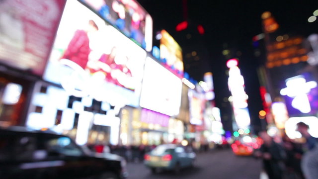 Night city lights and traffic background, New York, Times Square. Out of focus background with blurry unfocused city lights and driving cars and car light. Times Square, Manhattan, New York City.