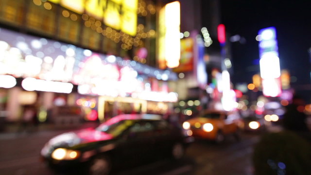 City at night background with cars. Out of focus background with blurry unfocused city lights. Times Square, Manhattan, New York City.