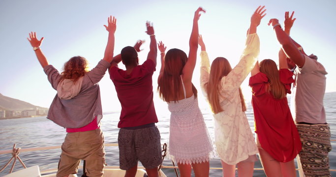 Multi ethnic group of friends looking at horizon from a yacht