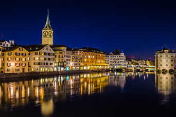 Night view of zurich from the munsterbrucke with building of the town hall on right side and saint...