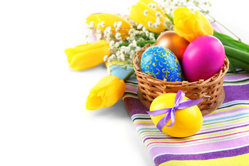 Multicoloured Easter eggs and tulips on napkin isolated on white