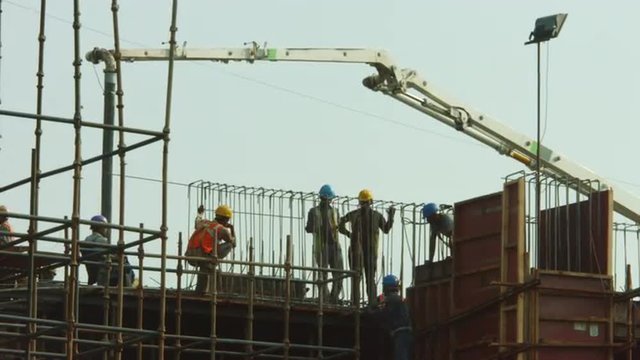 Time Lapse shot of manual workers working at a construction site