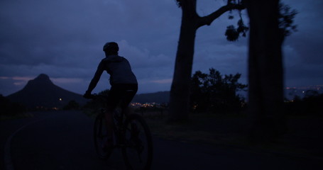 Low angle cropped shot of unrecognizable cyclist riding his bicycle - Powered by Adobe