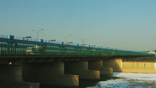 Time Lapse shot of vehicles moving on bridge over a river