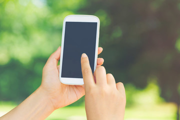 Woman using her smartphone in the forest