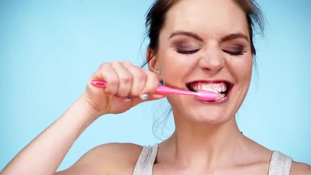 Woman brushing cleaning teeth 4K