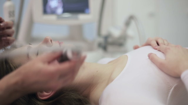 Health and beauty: Woman is massaged for reducing face with electronic massage system