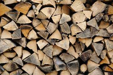 Fototapeta premium Stack of firewood. chopped wood stacked background 