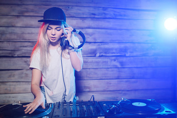 Cute dj woman having fun playing music at club party