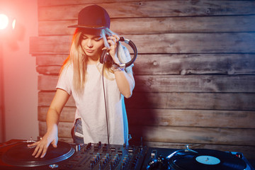 Cute dj woman having fun playing music at club party