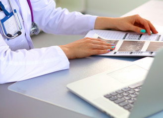 Portrait of happy medical doctor woman in office