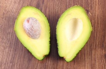 Avocado on wooden background, ingredient of avocado paste or guacamole, healthy food and nutrition