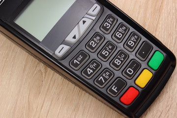Payment terminal, credit card machine on desk, finance concept