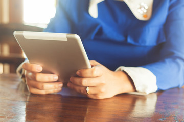 woman using tablet computer in cafe. Focus on tablet.