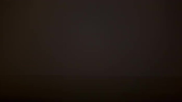 Timelapse shot of thunderstorm with many lightnings raging over the sea at night