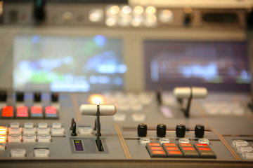 TV editor working with video and audio mixer