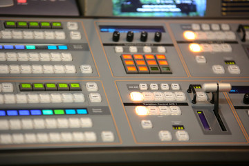TV editor working with video and audio mixer