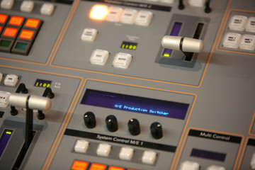 TV editor working with video and audio mixer