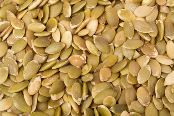 background of green peeled pumpkin seeds