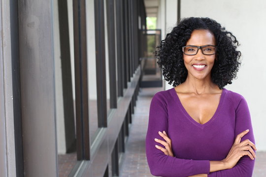 A pretty African american woman wearing glasses at work
