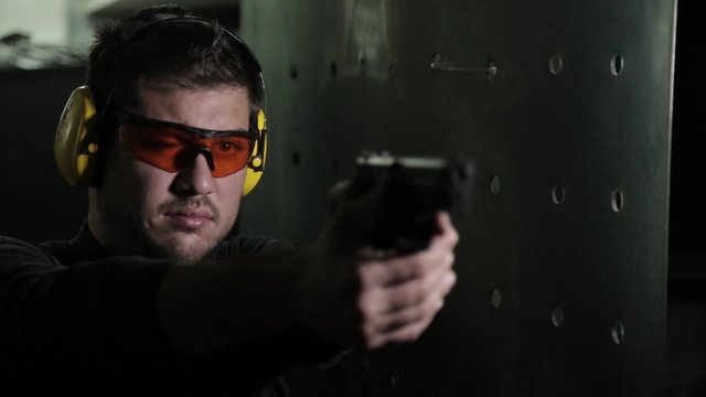 Aiming a pistol in a shooting range