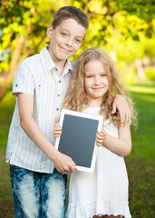 Children with tablet pc outdoors