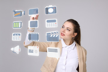 Woman pressing high tech type of modern multimedia buttons on a virtual background
