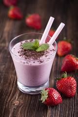 Tasty strawberry  shake on wooden table!