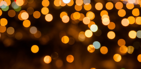 abstract festive background with bright golden lights, close up