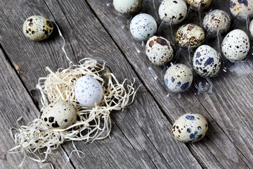 Quail eggs on a  wooden table, top view