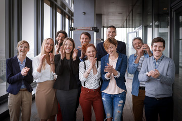 Fototapeta premium Group shot of business people in modern office hall. Post processed with vintage film filter.