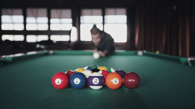 Man playing pool billiards first shot
