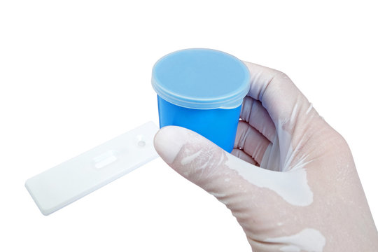blue urine container held by hand with pregnancy test Cassette 