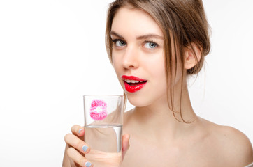 Beautiful Girl Drinking a Glass of Pure Water Smiling Holding on White