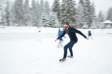 Fototapeta na wymiar Man ice skating outdoors