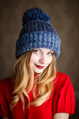 Portrait of playful woman in knitted winter cap